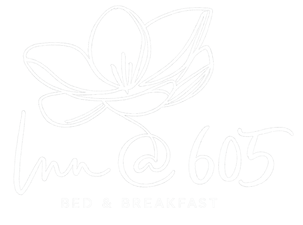 Logo for Inn @ 605 Bed & Breakfast featuring a stylized flower design.